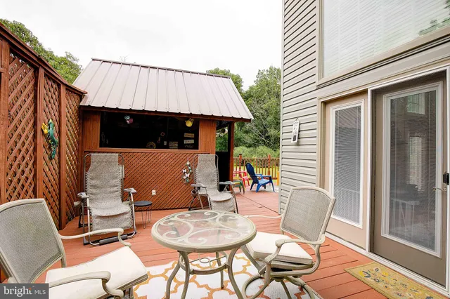 a view of a house with a yard and large trees