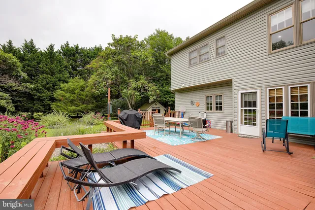 a large white kitchen with a large window and stainless steel appliances