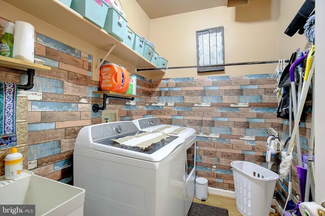a view of a livingroom with furniture wooden floor chandelier