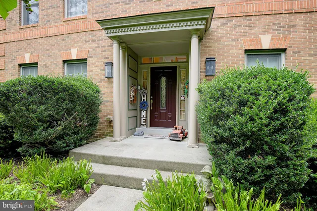 front view of a house with potted plants