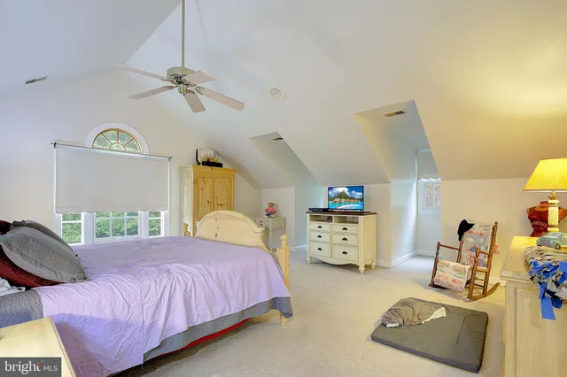 a living room with furniture and a ceiling fan