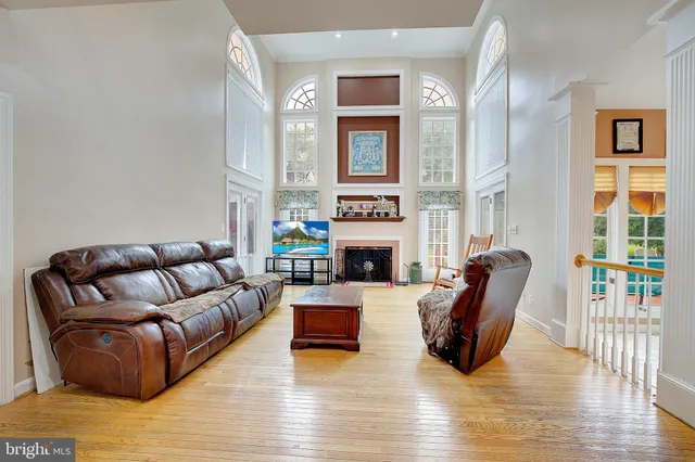 a living room with furniture a fireplace and a large window