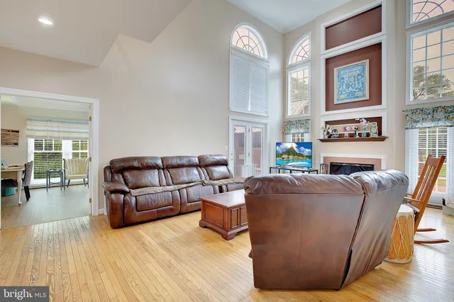 a living room with furniture wooden floor and a fireplace