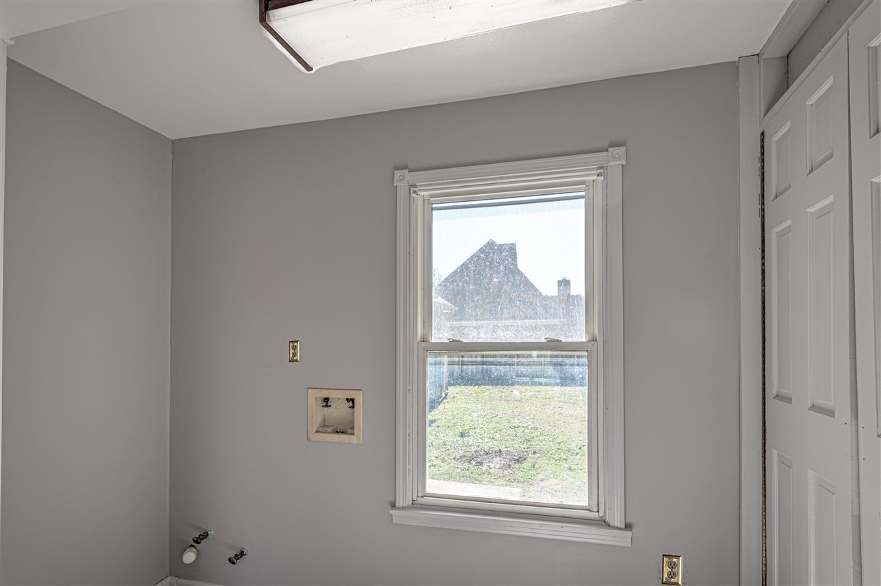 969 McQuiston Road Brighton, TN 38011 - Photo 11 of 25 a view of an empty room with wooden floor and a window
