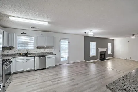 a view of a kitchen with a sink and a stove top oven