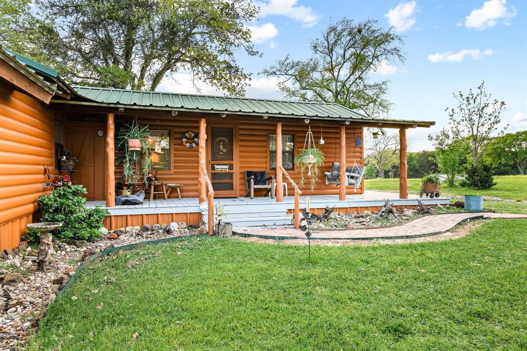 642 Earl Road Sadler, TX 76264 - Photo 2 of 40 a front view of a house with a yard table and chairs