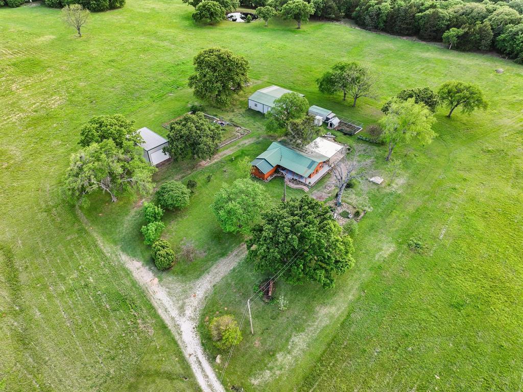 642 Earl Road Sadler, TX 76264 - Photo 39 of 40 a backyard of a house with a yard and outdoor seating