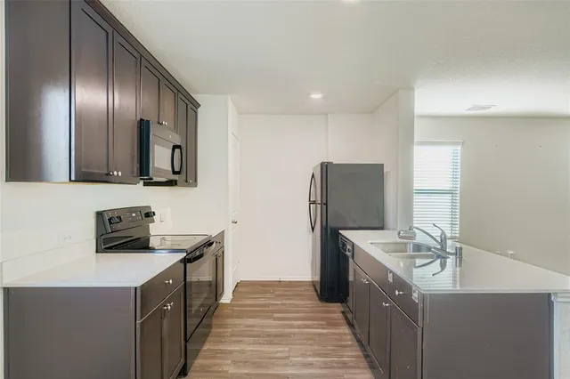 a kitchen with stainless steel appliances a sink stove and refrigerator