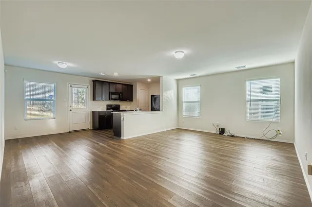 a view of kitchen with sink microwave refrigerator and cabinets