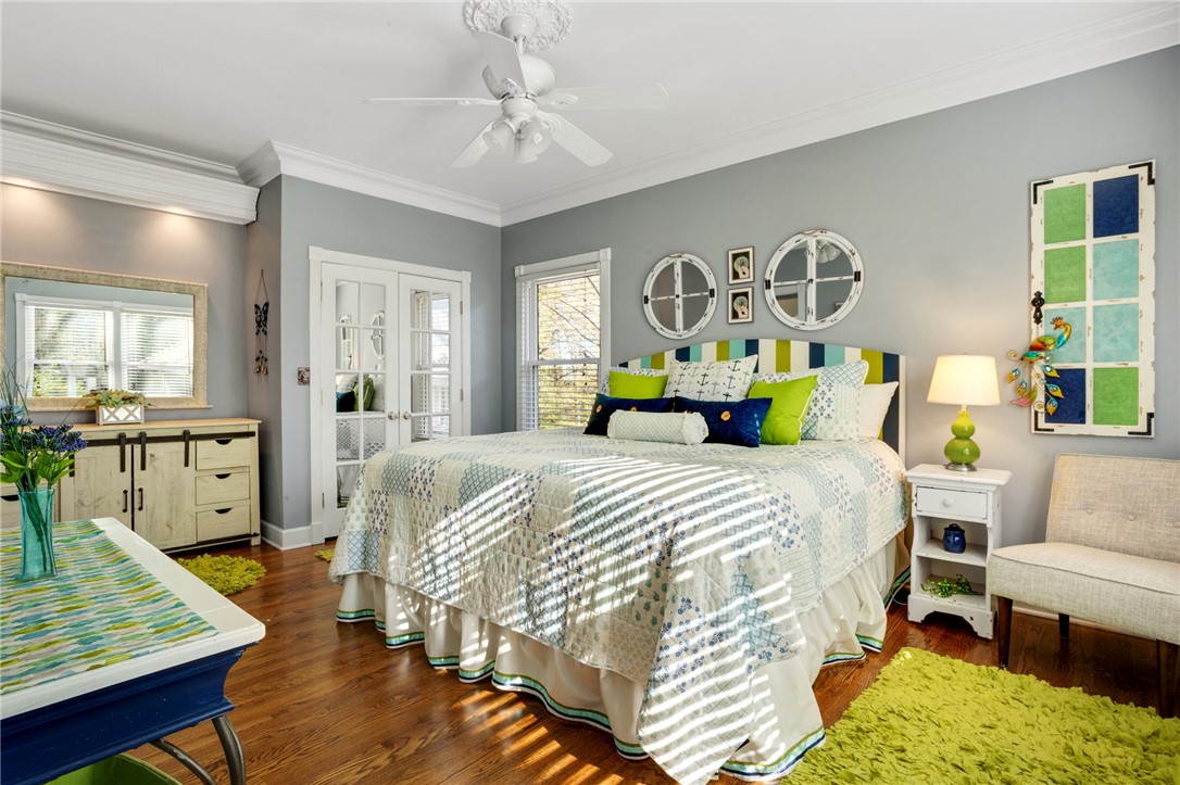 1133 Elrod Ferry Road Hartwell, GA 30643 - Photo 25 of 46 This airy bedroom boasts hardwood floors and elegant crown molding, creating a bright and inviting retreat.