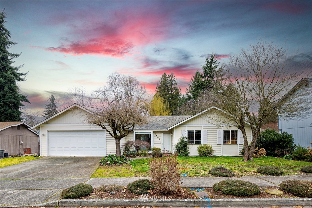 1908 Northeast 19th Place Renton, WA 98056 - Photo 1 of 23 a view of a house with a yard and large tree