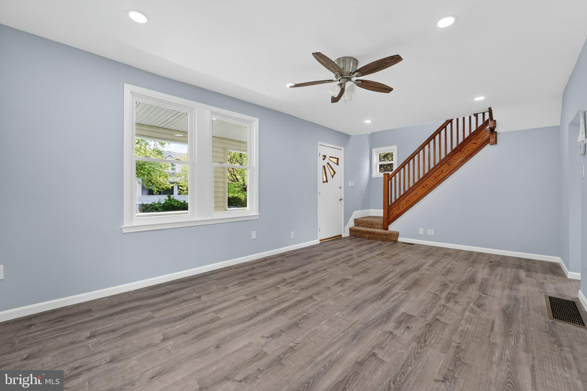 5312 Catalpha Road Baltimore, MD 21214 - Photo 54 of 59 a view of empty room with wooden floor and fan
