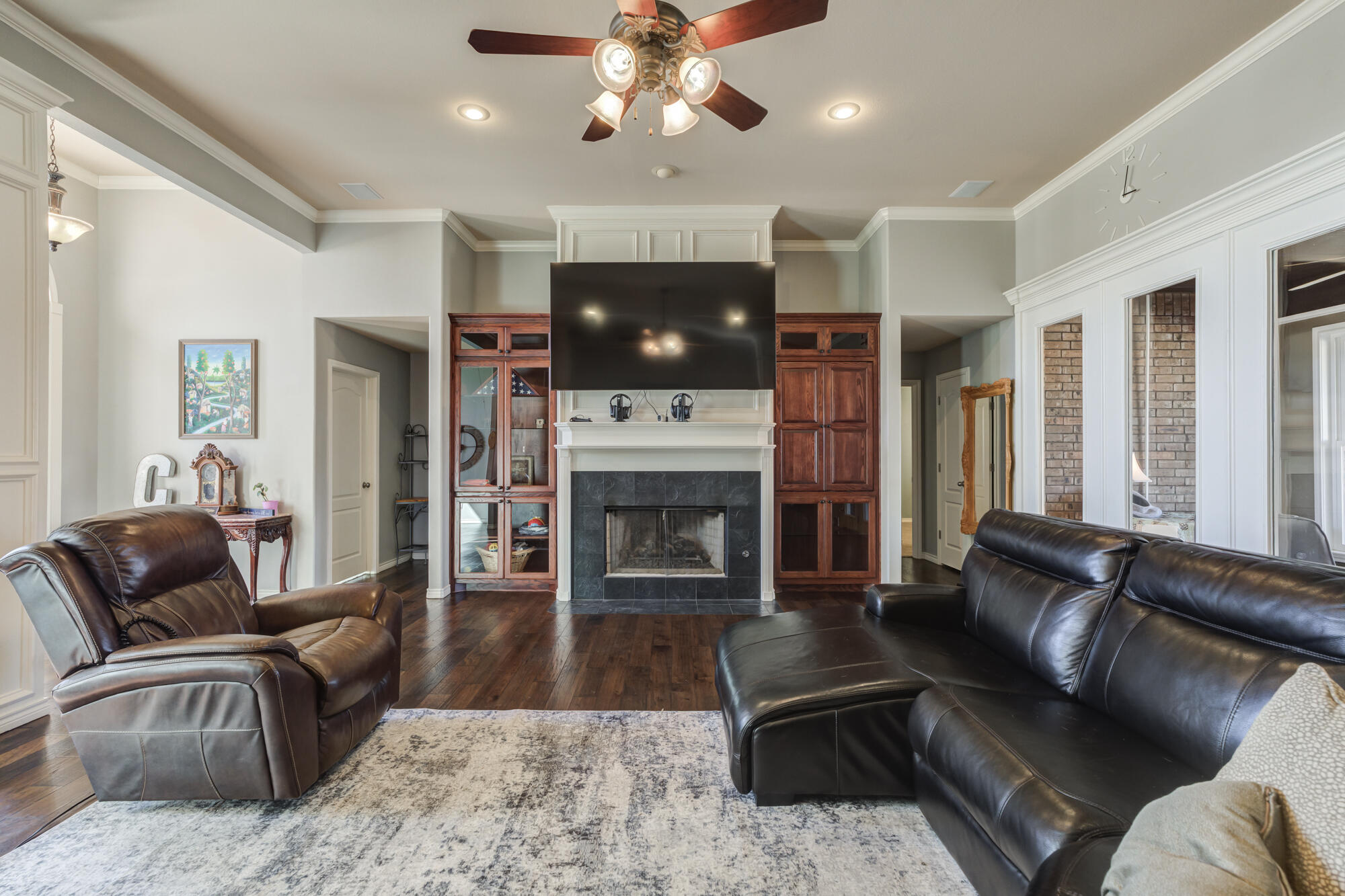 6302 County Road 7435 Lubbock, TX 79424 - Photo 12 of 59 a living room with furniture a fireplace and a flat screen tv