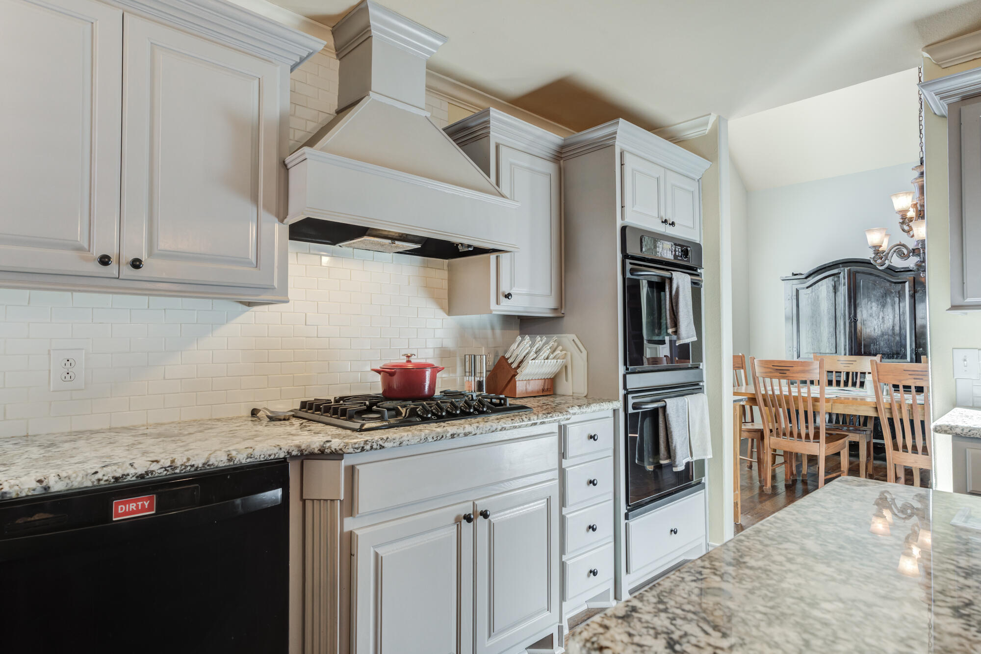 6302 County Road 7435 Lubbock, TX 79424 - Photo 17 of 59 a kitchen with stainless steel appliances a sink a stove and cabinets