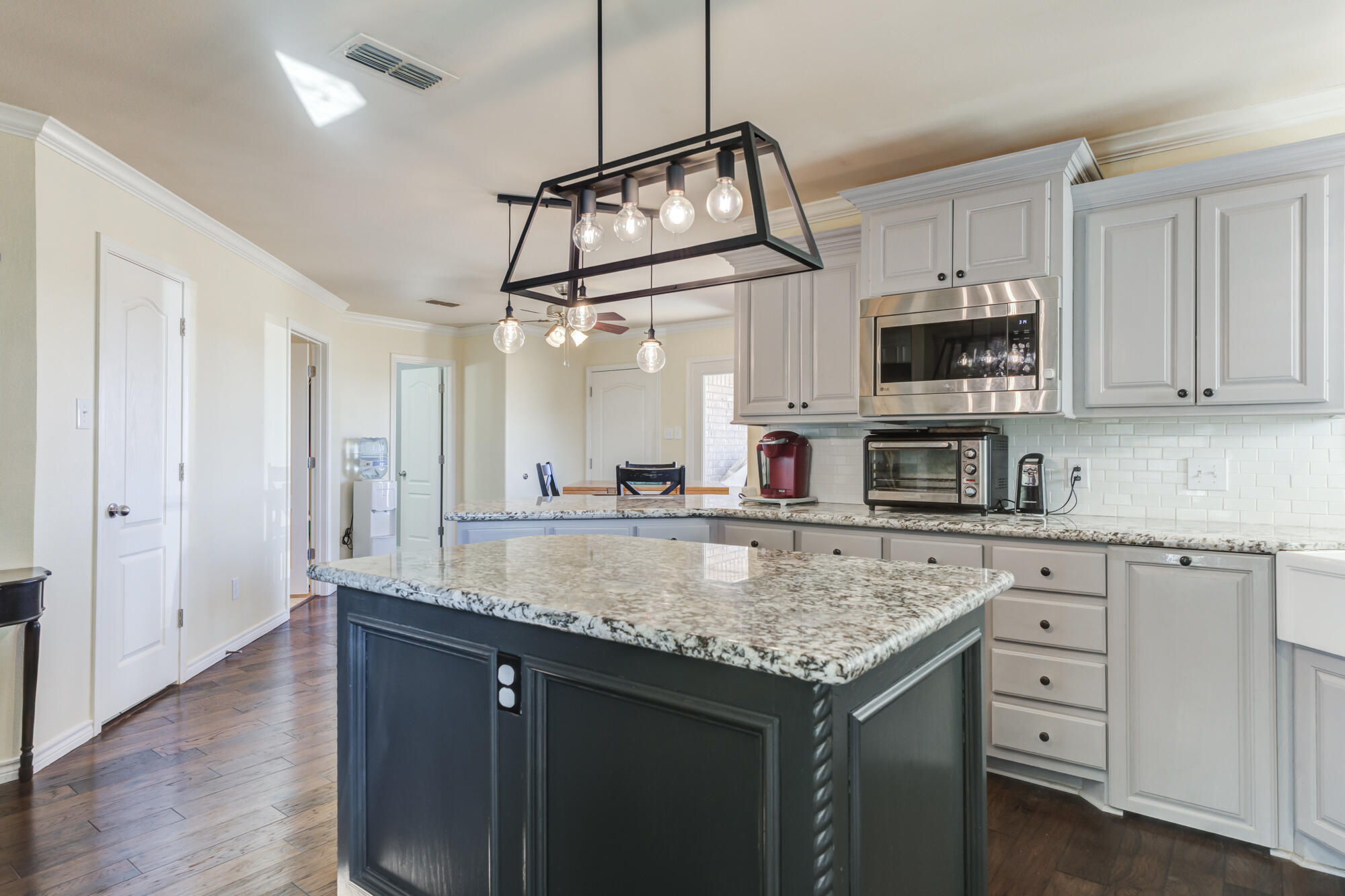 6302 County Road 7435 Lubbock, TX 79424 - Photo 18 of 59 a kitchen with stainless steel appliances granite countertop a sink a stove and cabinets