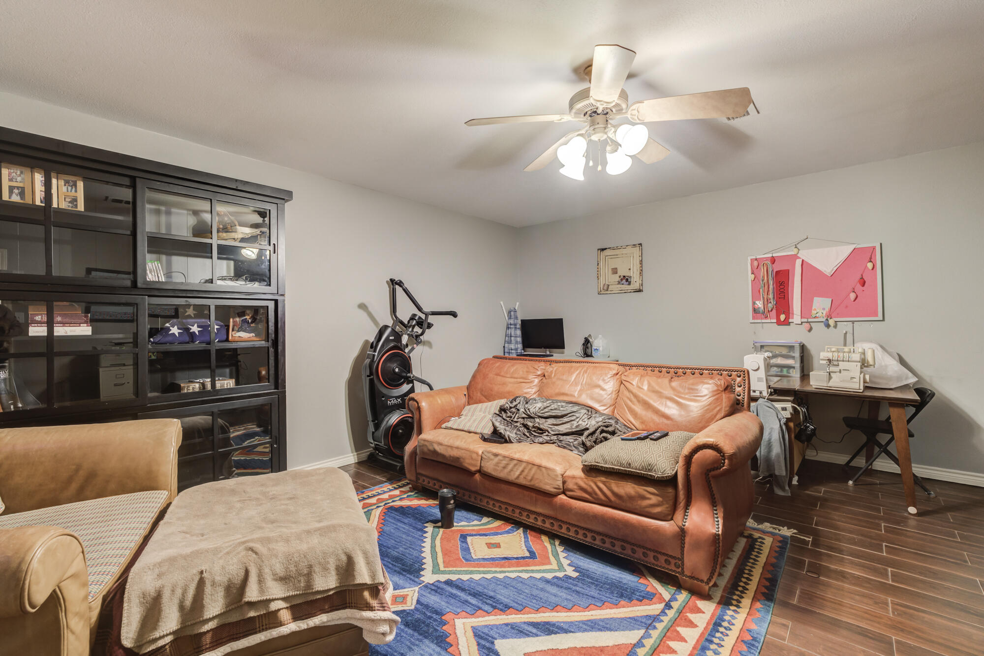 6302 County Road 7435 Lubbock, TX 79424 - Photo 25 of 59 a living room with furniture and a flat screen tv with kitchen view
