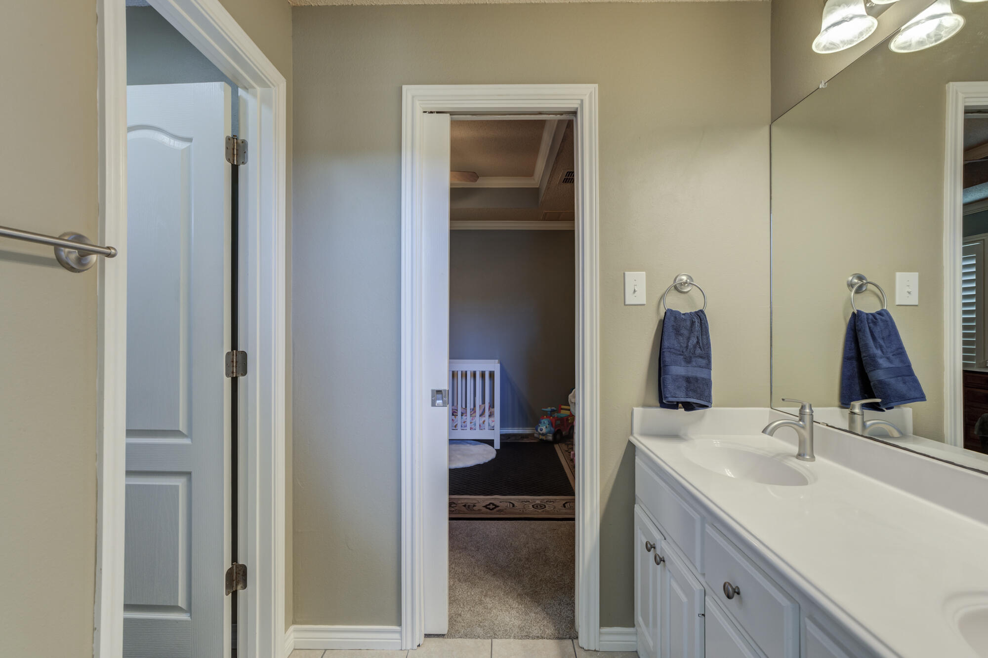 6302 County Road 7435 Lubbock, TX 79424 - Photo 28 of 59 a bathroom with a sink and a mirror