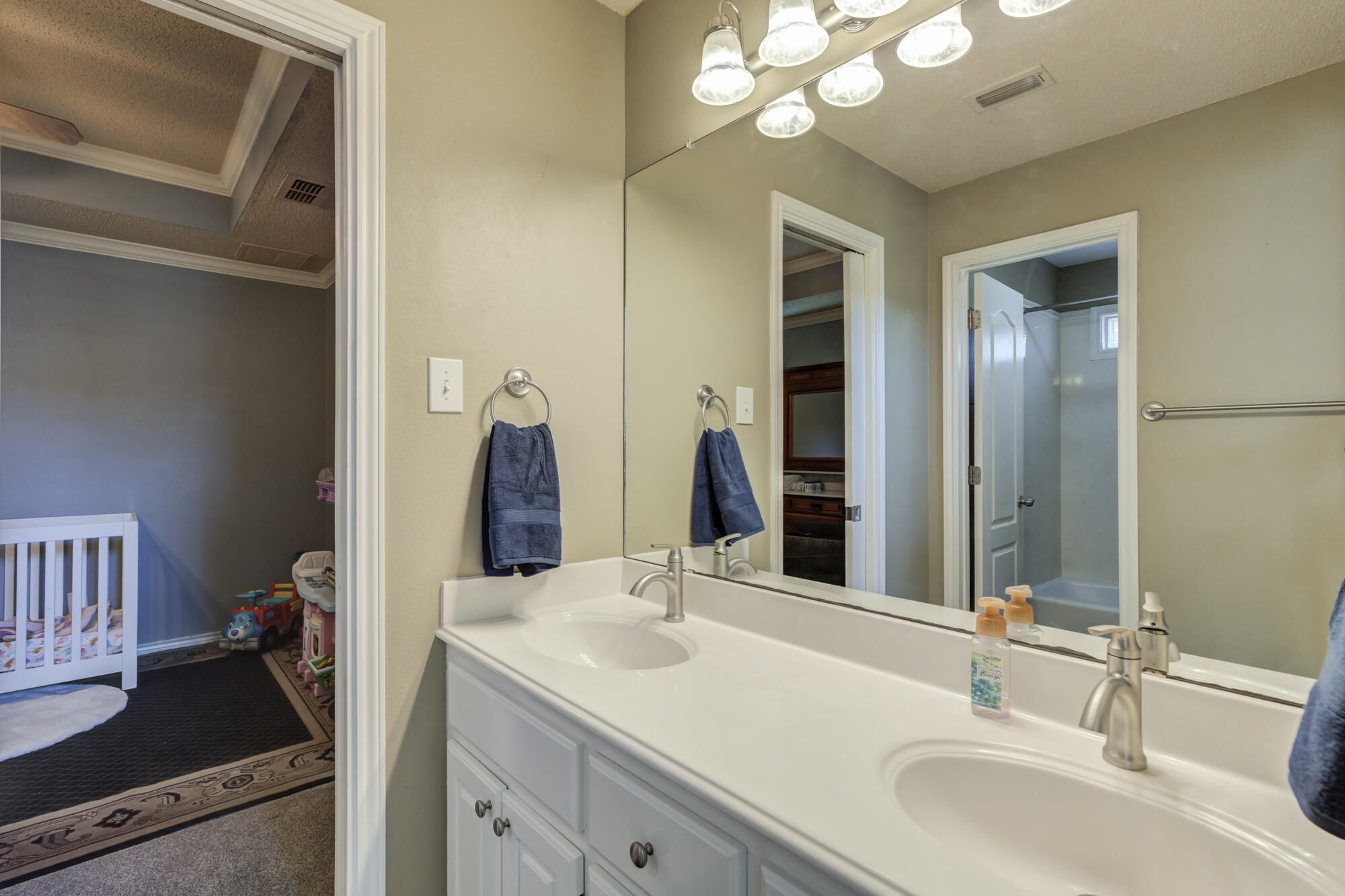 6302 County Road 7435 Lubbock, TX 79424 - Photo 29 of 59 a bathroom with a sink and a mirror