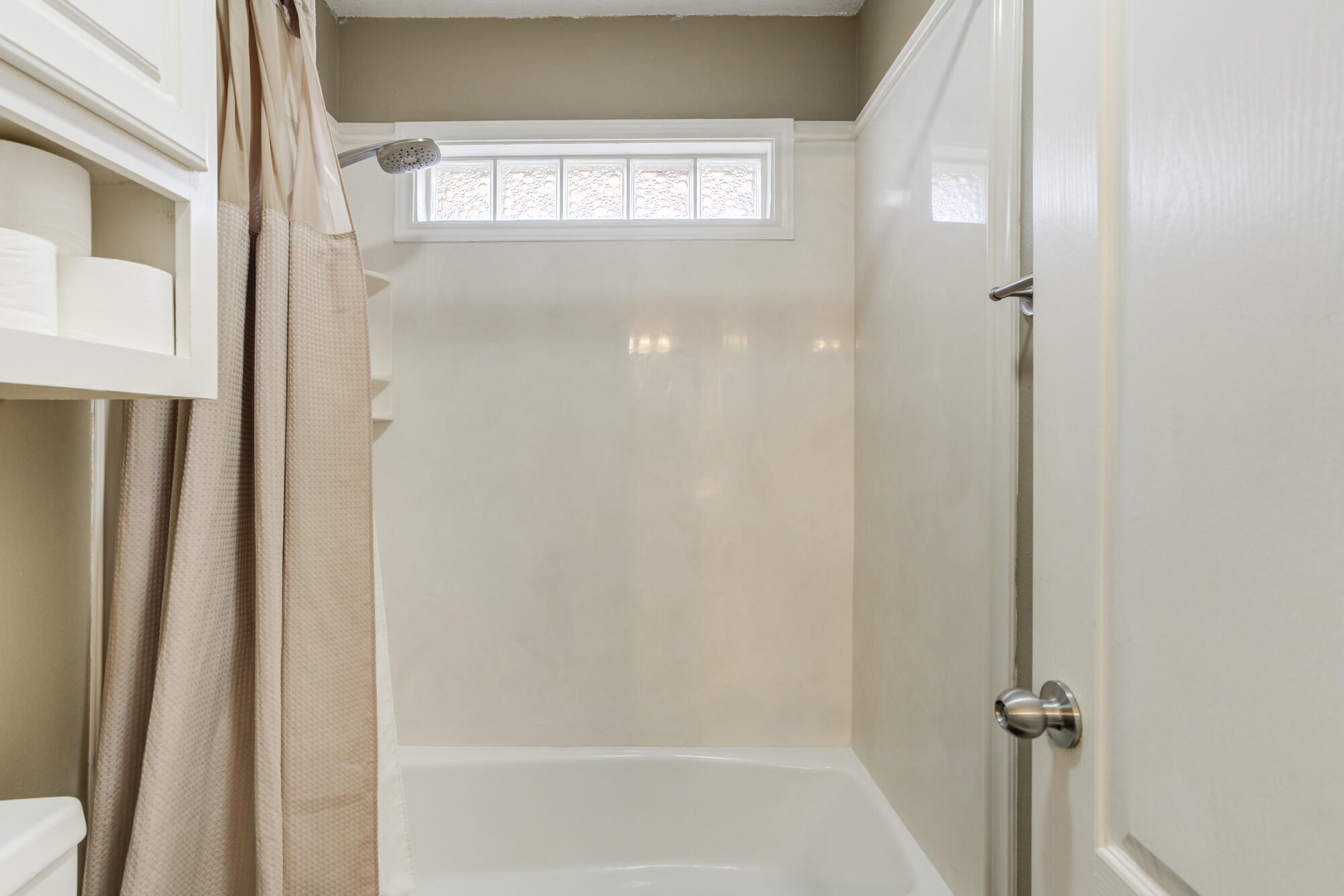 6302 County Road 7435 Lubbock, TX 79424 - Photo 30 of 59 a bathroom with a glass shower door