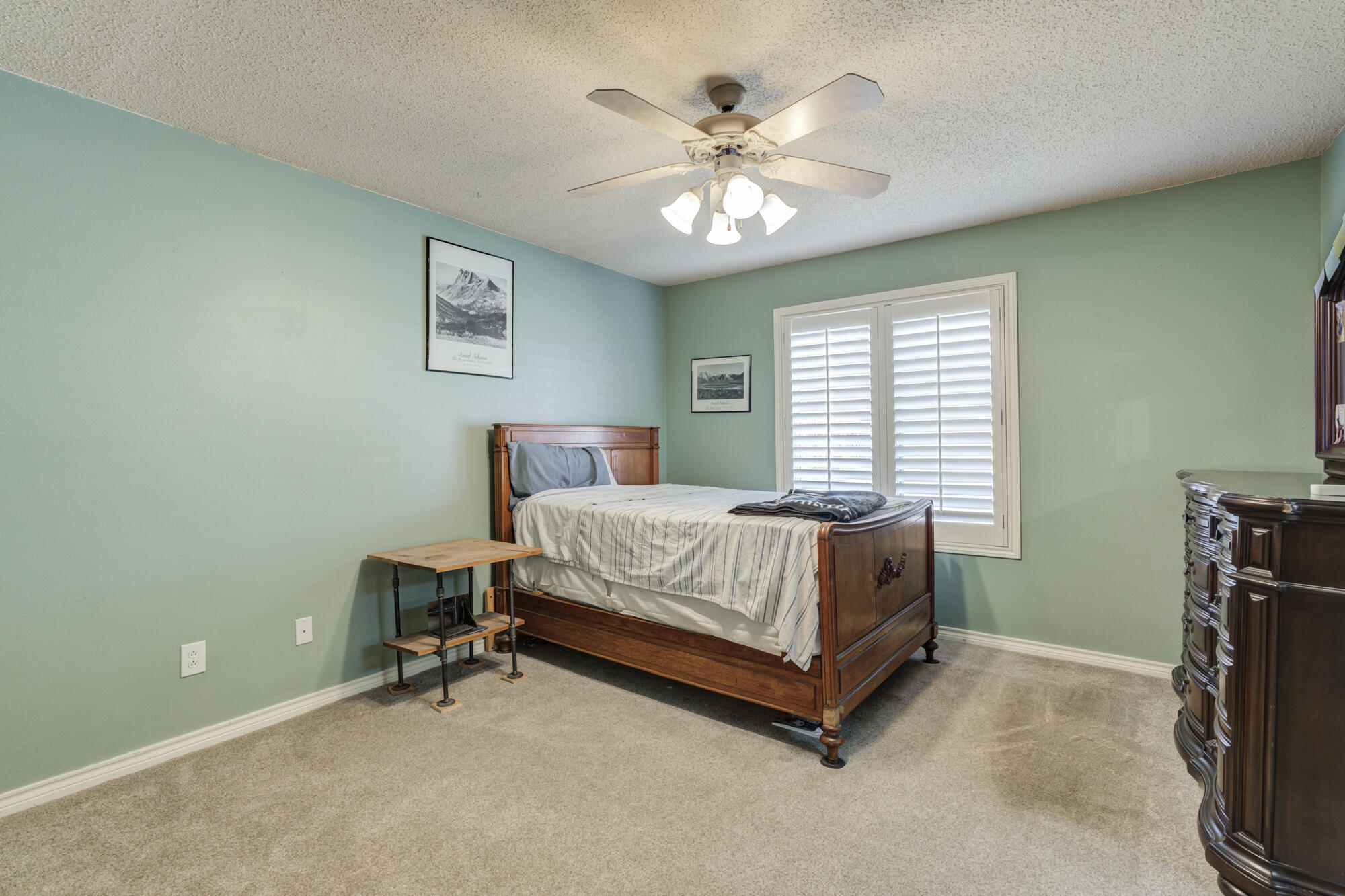 6302 County Road 7435 Lubbock, TX 79424 - Photo 33 of 59 a bed sitting in a bedroom next to a window