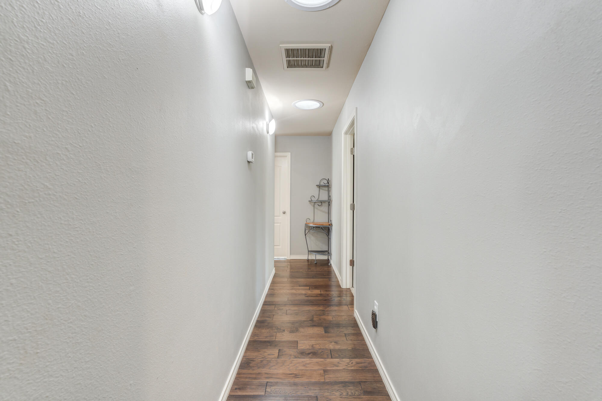 6302 County Road 7435 Lubbock, TX 79424 - Photo 36 of 59 a view of a hallway with wooden floor
