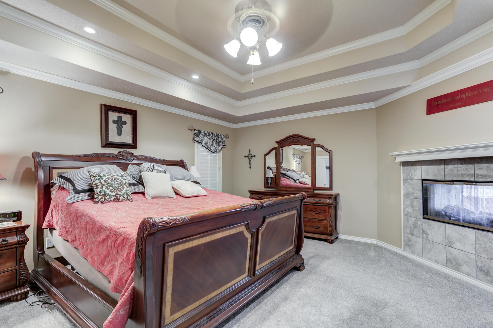 6302 County Road 7435 Lubbock, TX 79424 - Photo 37 of 59 a bedroom with bed and a chandelier