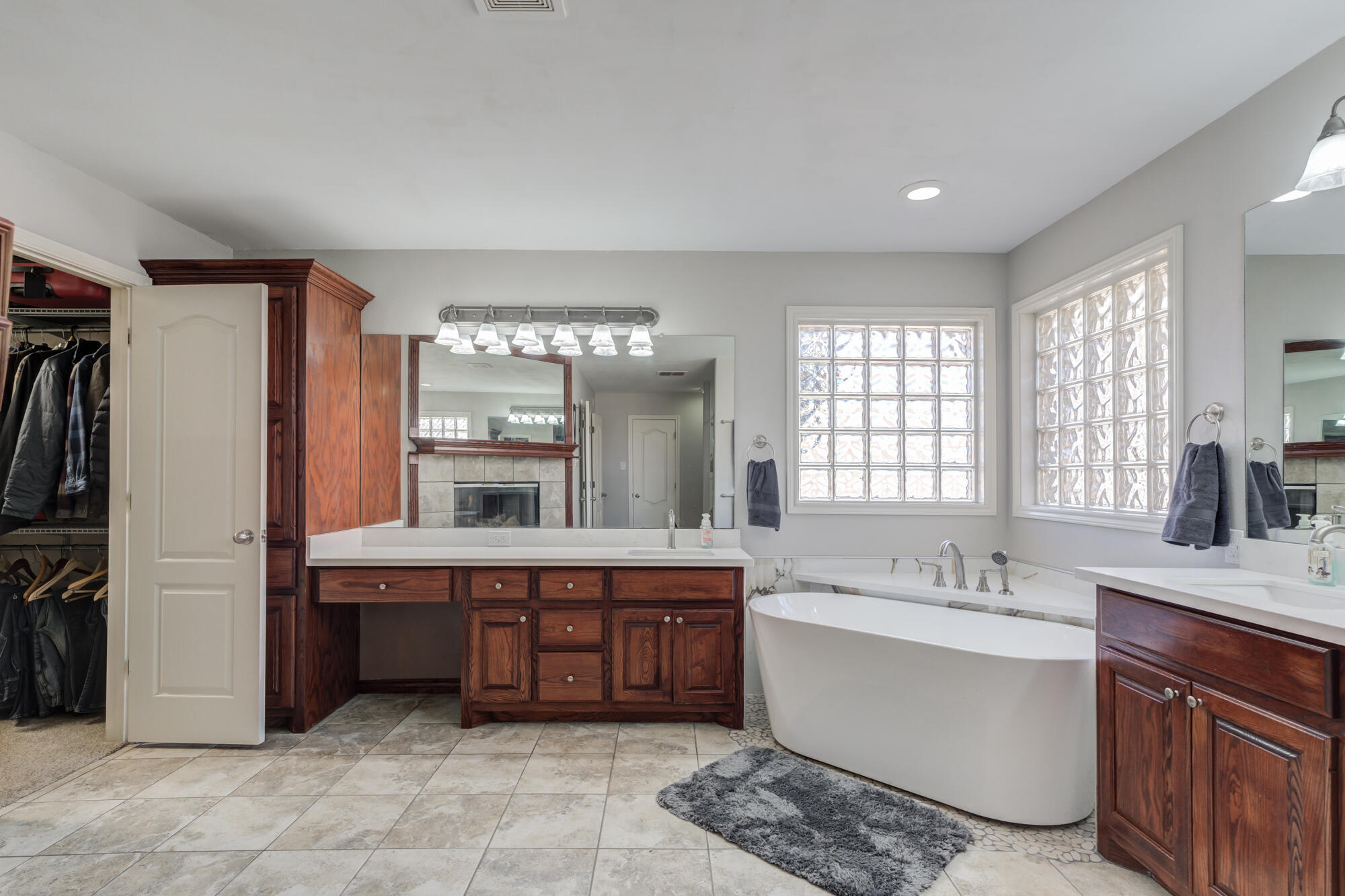 6302 County Road 7435 Lubbock, TX 79424 - Photo 40 of 59 a large bathroom with a double vanity sink large mirror and bathtub