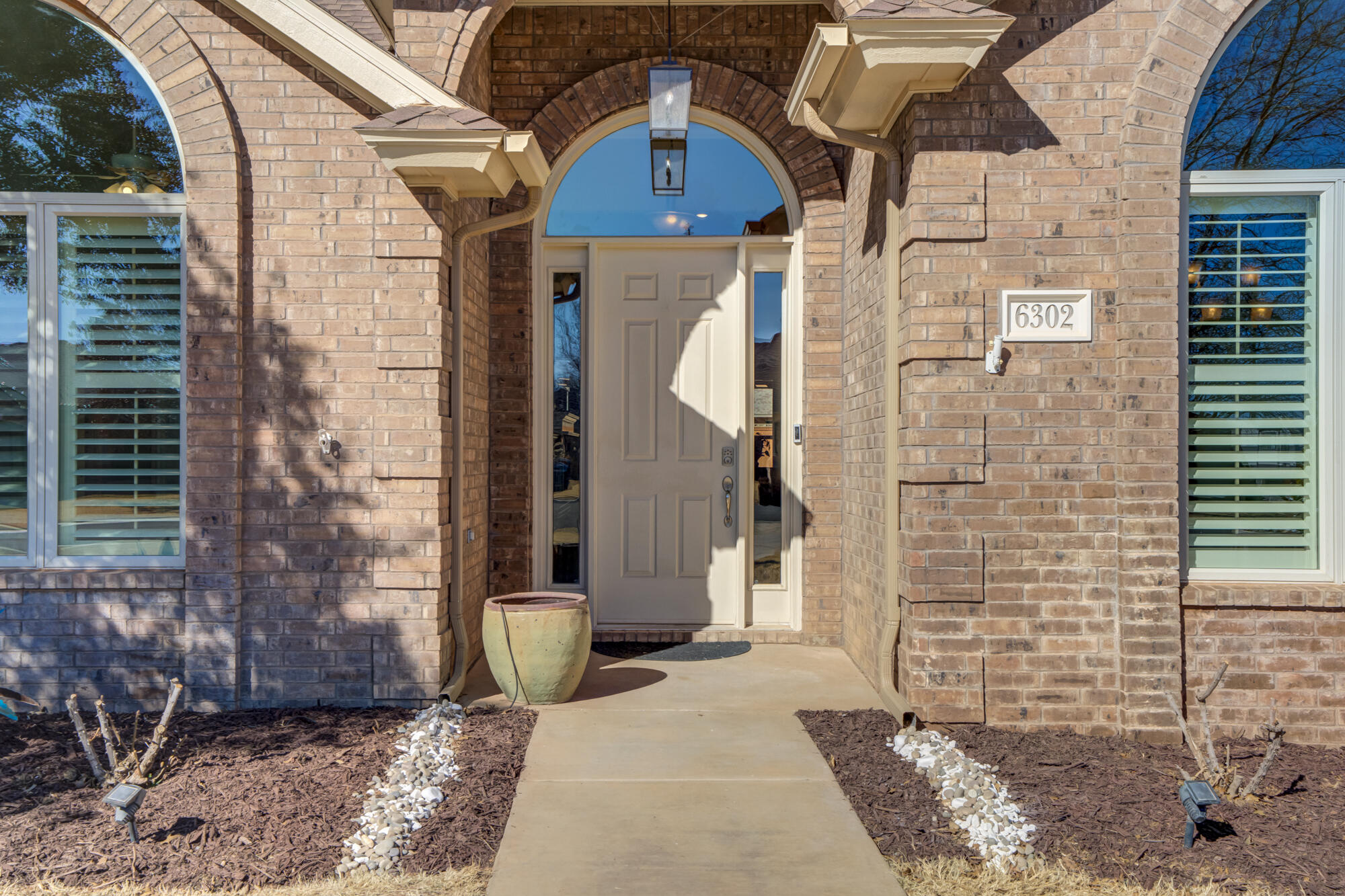 6302 County Road 7435 Lubbock, TX 79424 - Photo 4 of 59 a view of a brick house with many windows