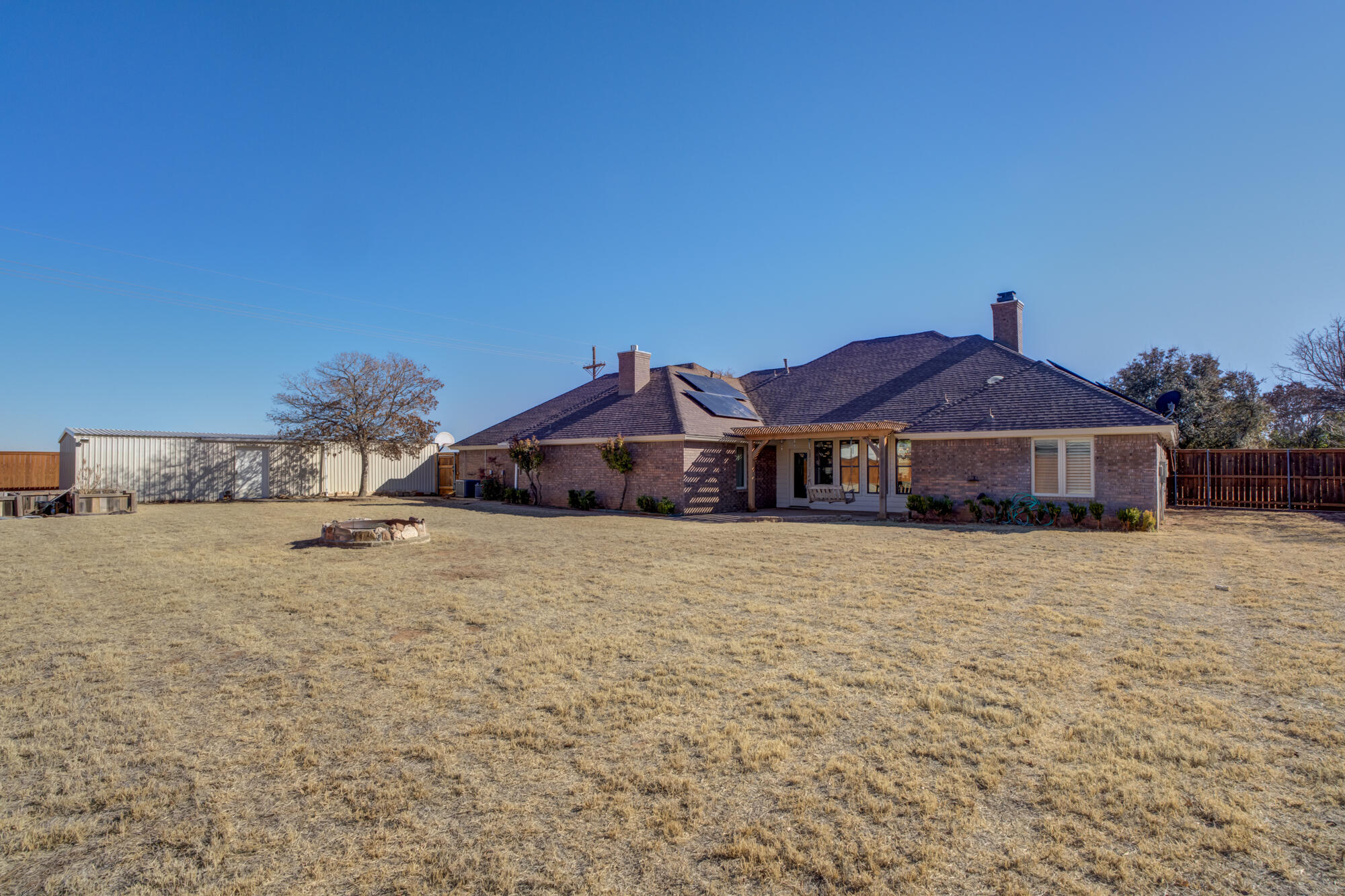6302 County Road 7435 Lubbock, TX 79424 - Photo 52 of 59 a front view of a house with a yard and garage