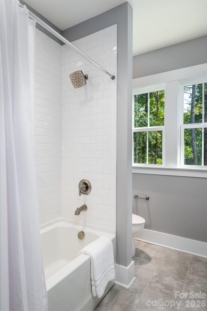 116 Silver Falls Road Troutman, NC 28166 - Photo 36 of 46 a bathroom with a bathtub toilet and window