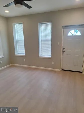 an empty room with windows and mirror