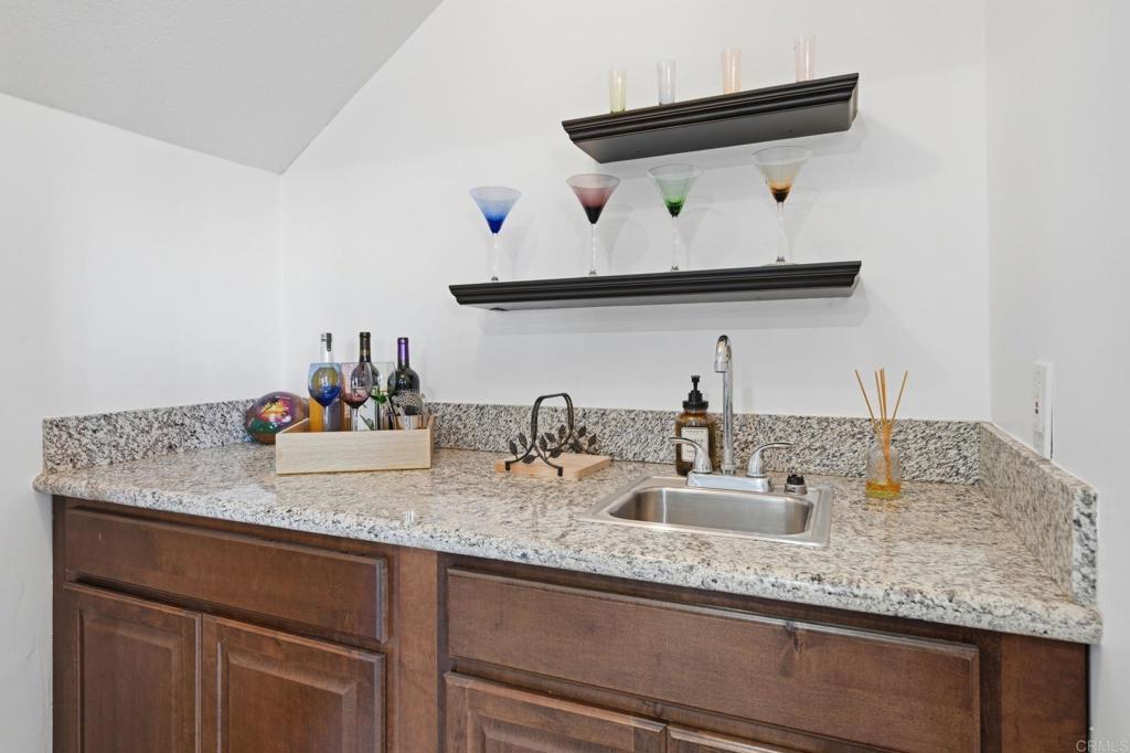 3328 Central Avenue Spring Valley, CA 91977 - Photo 21 of 54 a bathroom with a granite countertop sink and a mirror