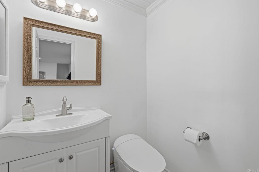 3328 Central Avenue Spring Valley, CA 91977 - Photo 22 of 54 a bathroom with a toilet sink and mirror