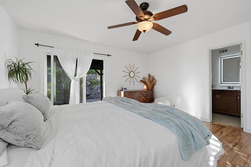 3328 Central Avenue Spring Valley, CA 91977 - Photo 25 of 54 a bedroom with a large bed and a chandelier