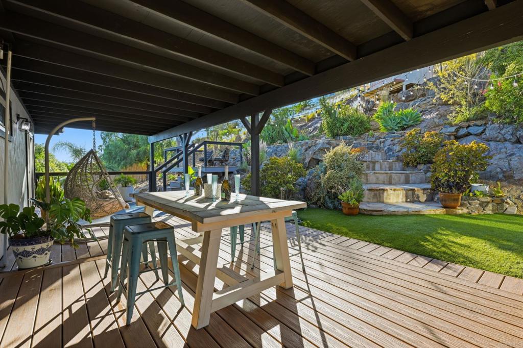 3328 Central Avenue Spring Valley, CA 91977 - Photo 31 of 54 a view of a patio with table and chairs potted plants and floor to ceiling window with wooden floor