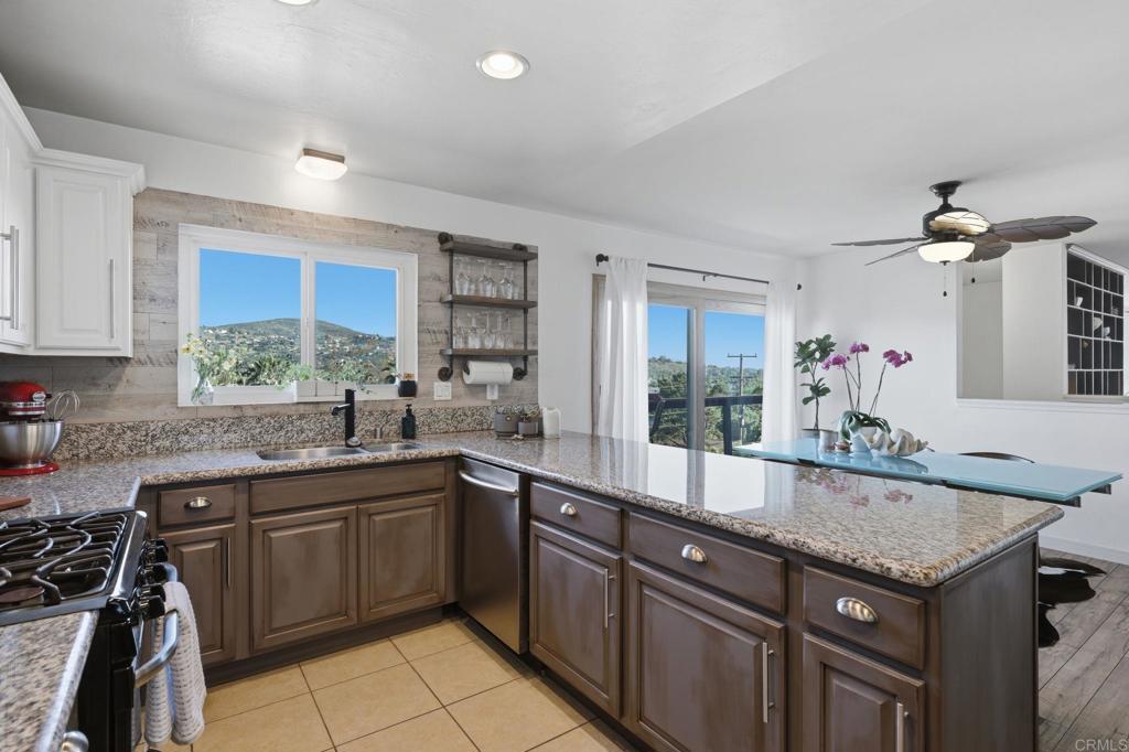 3328 Central Avenue Spring Valley, CA 91977 - Photo 5 of 54 a kitchen with granite countertop a sink stove and cabinets