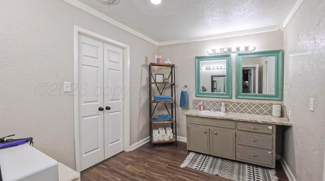 1402 Marigold Street Borger, TX 79007 - Photo 13 of 18 a bathroom with a sink and a mirror