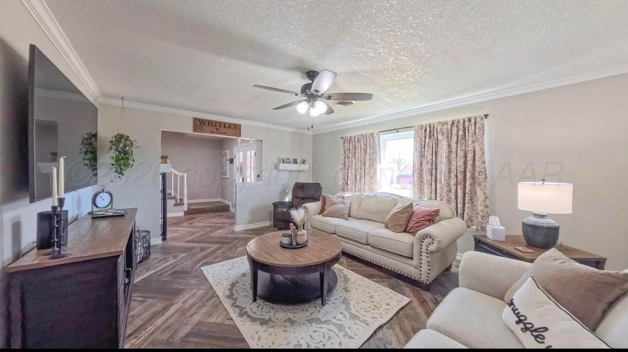 1402 Marigold Street Borger, TX 79007 - Photo 3 of 18 a living room with furniture a chandelier and a window