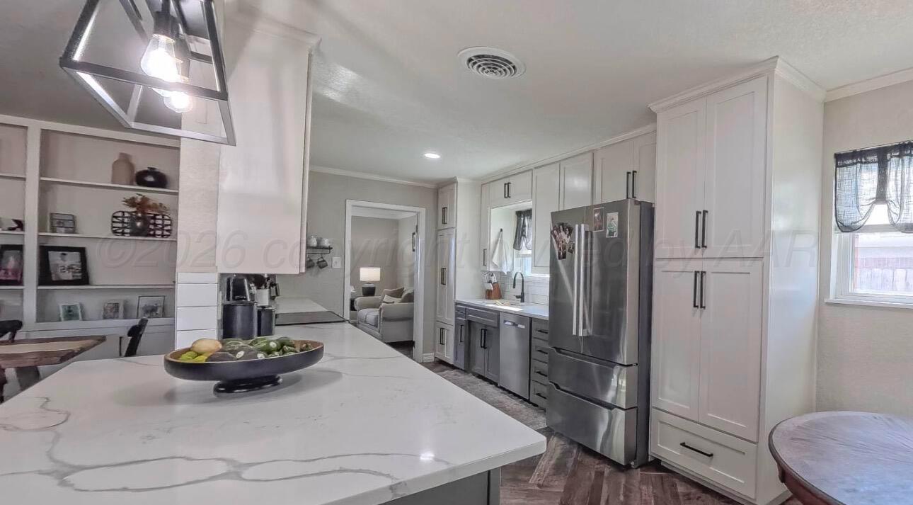 1402 Marigold Street Borger, TX 79007 - Photo 4 of 18 a kitchen with refrigerator and window