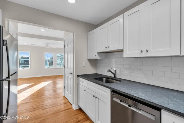 a kitchen with sink and cabinets