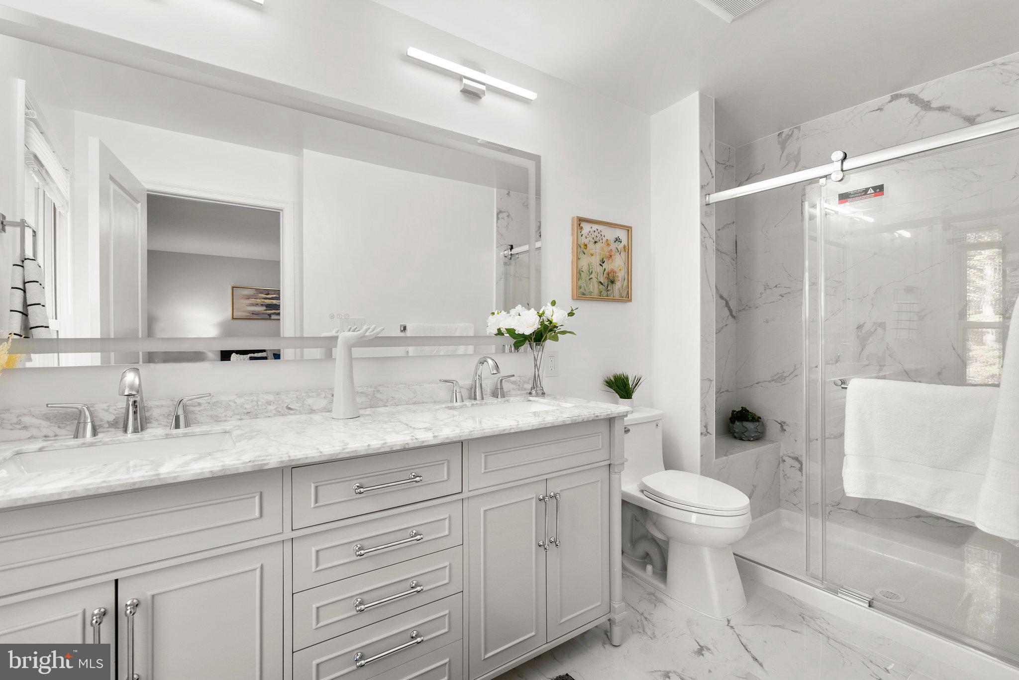 225 Hermleigh Road Silver Spring, MD 20902 - Photo 13 of 29 a bathroom with a granite countertop sink a toilet and a large mirror