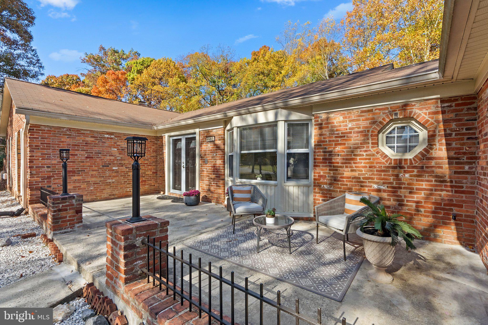 225 Hermleigh Road Silver Spring, MD 20902 - Photo 4 of 29 a view of a patio with table and chairs and potted plants