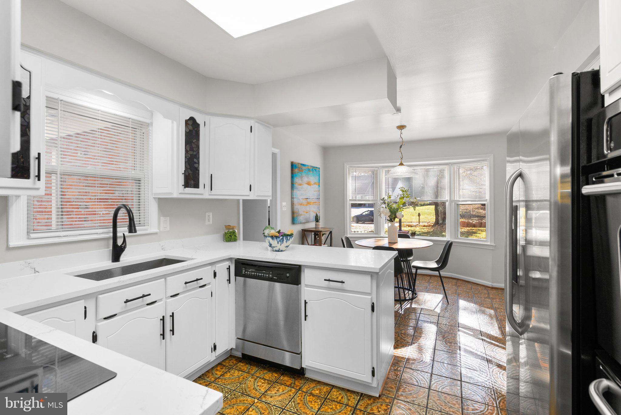 225 Hermleigh Road Silver Spring, MD 20902 - Photo 8 of 29 a kitchen with a sink cabinets and window