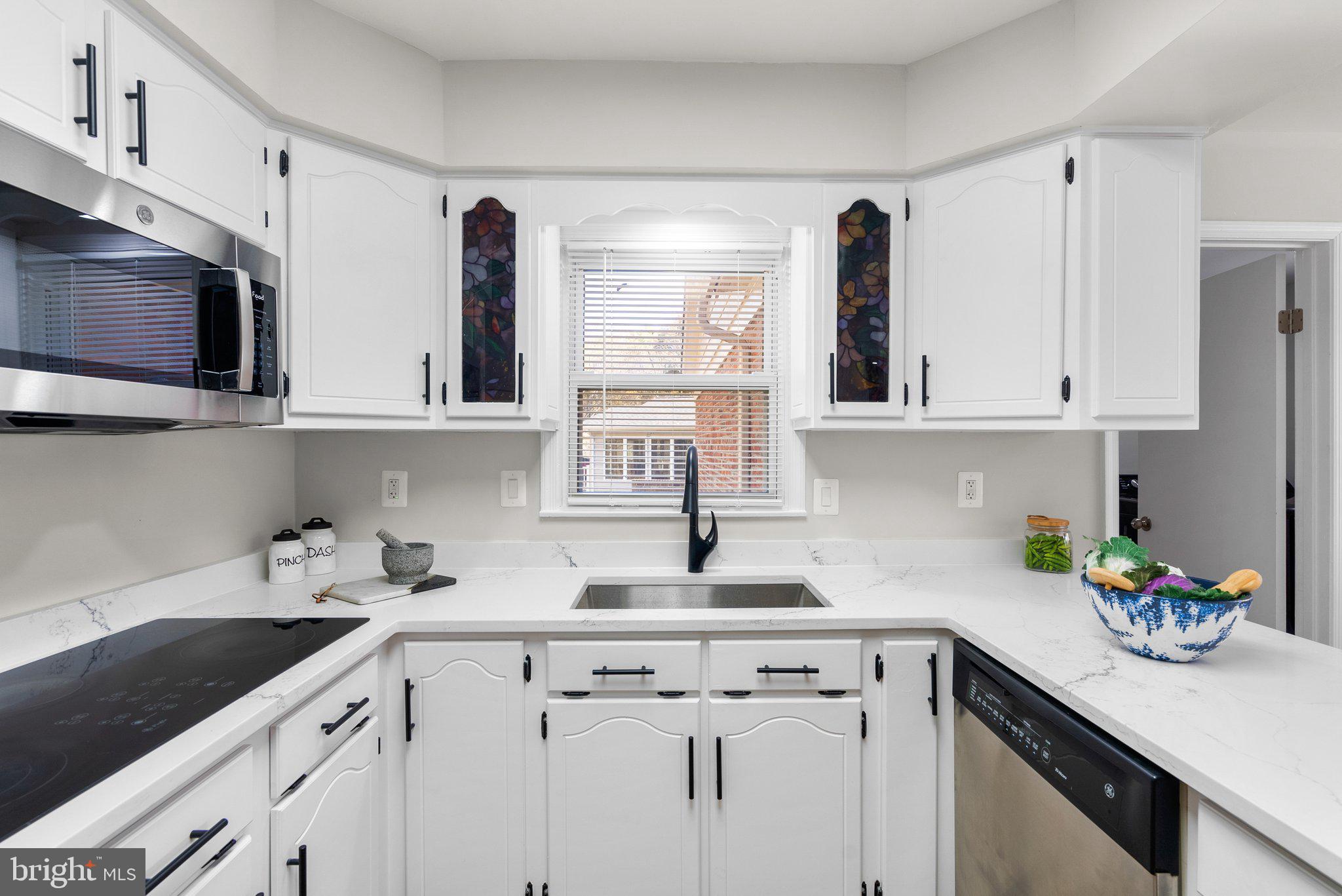 225 Hermleigh Road Silver Spring, MD 20902 - Photo 9 of 29 a kitchen with stainless steel appliances granite countertop white cabinets sink and dishwasher
