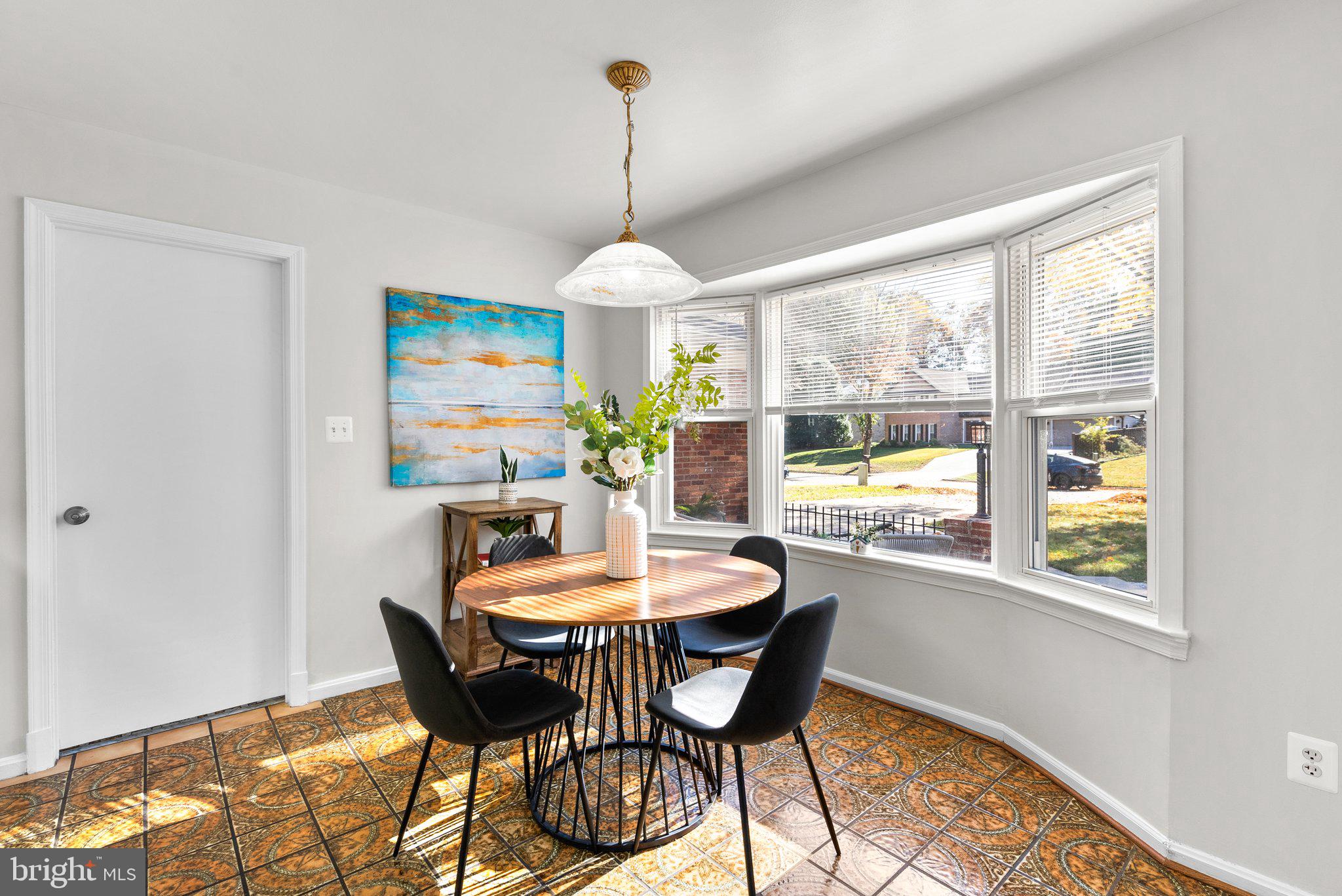 225 Hermleigh Road Silver Spring, MD 20902 - Photo 10 of 29 a dining room with furniture a chandelier and wooden floor