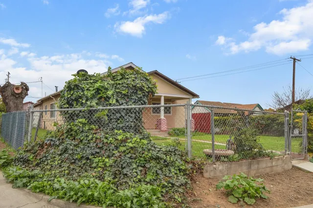 a backyard of a house with plants and outdoor seating
