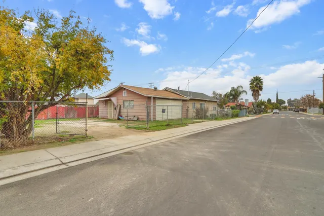 a view of a house with a yard and garage