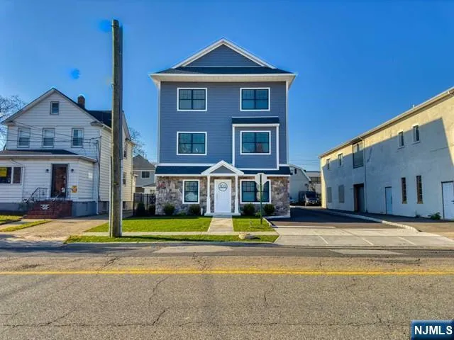 a view of a house with swimming pool next to a yard