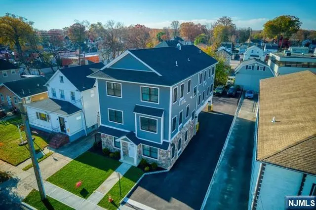 an aerial view of a house with a yard