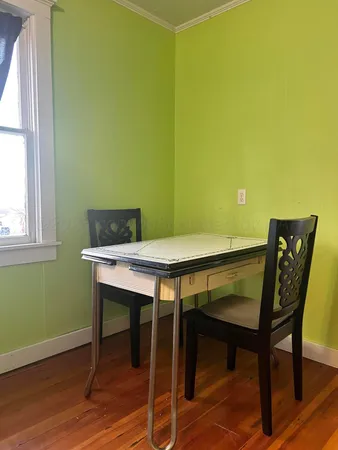 a view of a workspace with furniture and wooden floor